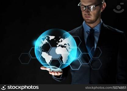 business, virtual reality, future technology and people concept - close up of businessman in suit with earth projection over dark background. close up of businessman with earth projection