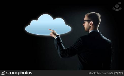 business, virtual reality, future technology, cyberspace and people - businessman in suit and glasses pointing finger to cloud projection over black background. businessman pointing finger to cloud projection