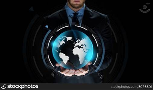 business, virtual reality, people and future technology concept - close up of businessman in suit with earth projection on hand over dark background. close up of businessman with earth projection