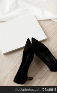 business woman accessories. black high heels and magazine with mock up.. business woman accessories. black high heels and magazine with mock up