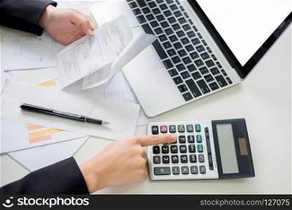 business woman accountant or banker making calculations Bills. doing finances in the office, economy concept through laptop.