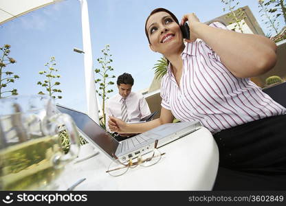 Business woman and business man working outdoors