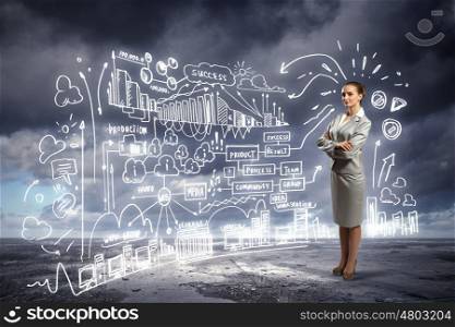 Business woman and business project. Image of businesswoman standing against business sketch