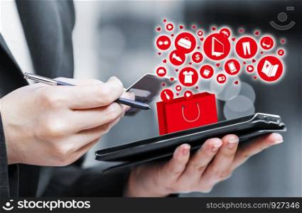 Business woman are shopping online by using mobile phone and credit card