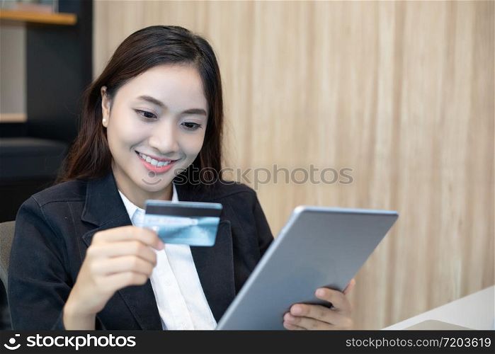 business woman asian using tablet and credit card shopping online
