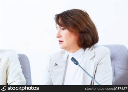 Business woman at meeting. Image of businesswoman at business meeting speakig in microphone