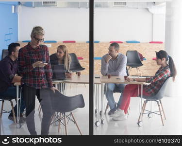 business woman at modern startup office interior talking by phone, people group team on meeting in background