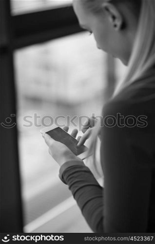 business woman at office using smart phone to surf internet and type messages