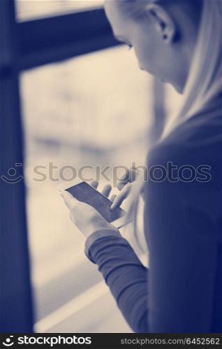 business woman at office using smart phone to surf internet and type messages