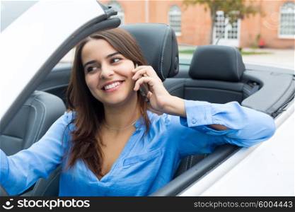 Business woman at the phone while driving