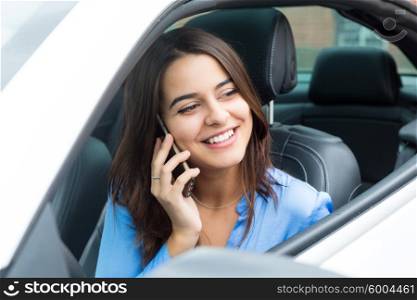Business woman at the phone while driving