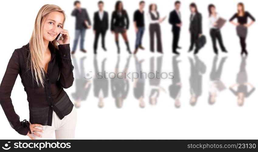 Business woman at the phone with group of people in the back