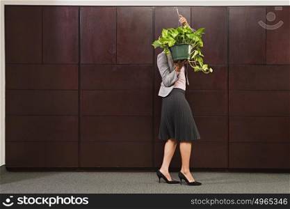 Business woman carrying plant
