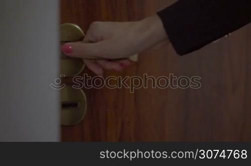 business woman coming home from work opening the door with the key