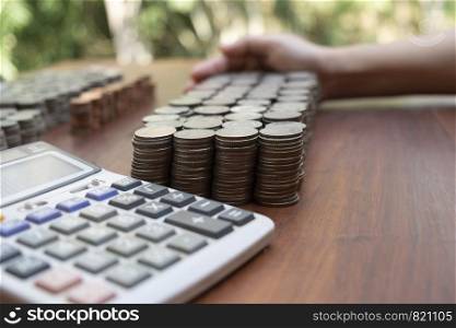 Business woman counting lots stack coins on wooden desk background texture, Money for business planning investment and saving concept