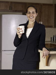 Business woman drinks coffee in the kitchen