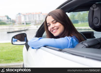 Business woman driving her new sports car