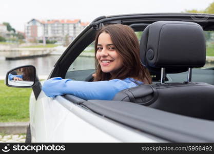 Business woman driving her new sports car