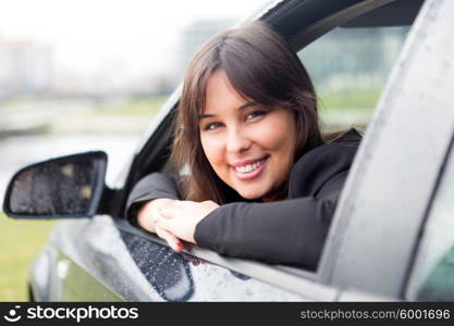 Business woman driving her new sports car