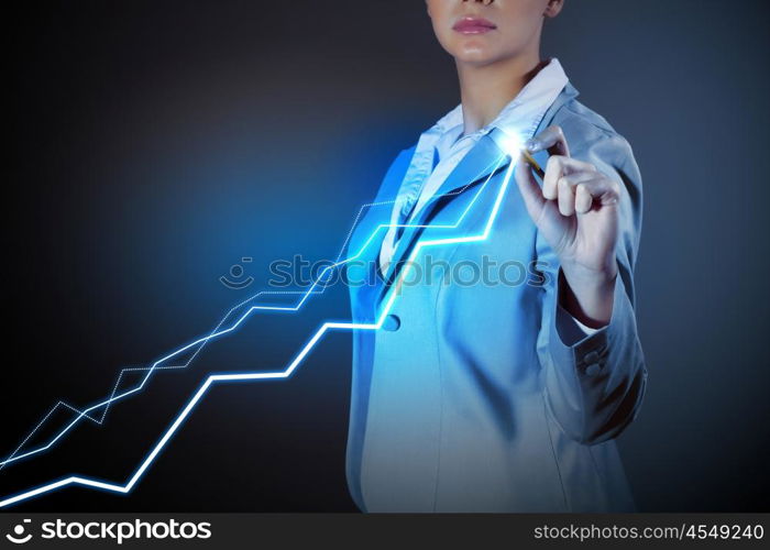 Business woman drowing media graphs. Image of businesswoman in grey suit drawing graph