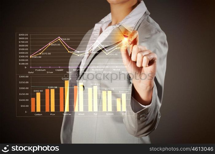 Business woman drowing media graphs. Image of businesswoman in grey suit drawing graph
