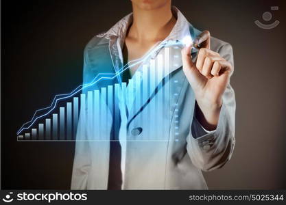 Business woman drowing media graphs. Image of businesswoman in grey suit drawing graph