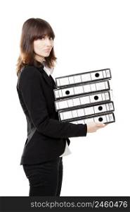 Business woman full of work holding a pile of folders, isolated on white background