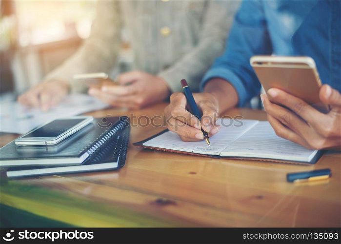 business woman hand working on smart phone  business graph infor. business woman hand working on smart phone  business graph information diagram on wooden table with window reflection at office.