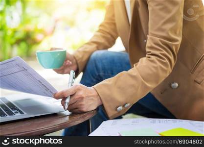 business woman hand working using laptop on table in garden