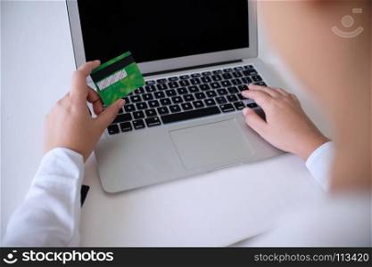 Business Woman Hands holding plastic credit card and using laptop smart phone Online shopping concept