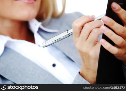 business woman hold a folder of papers and write