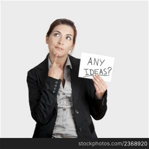 Business woman holding a card board with the text message  Any Ideas 