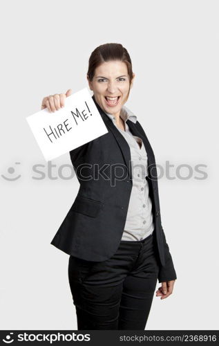 Business woman holding a card board with the text message  Hire me 