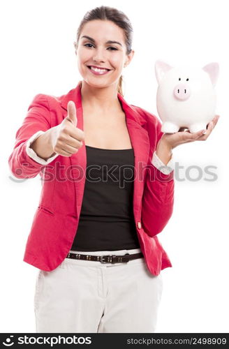 Business woman holding a piggy bank and doing thumbs up, isolated over a white background