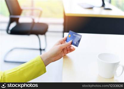 Business woman holding credit card payment in a office / payment online shopping paying with credit card technology e wallet concept