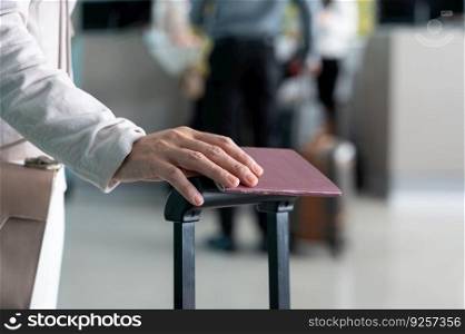 Business woman holding passport with luggage at airport terminal, travel and tourism concept