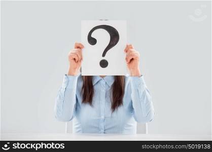 Business woman holding question mark signboard paper in front of face