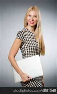 Business woman holding silver laptop
