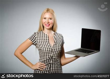 Business woman holding silver laptop