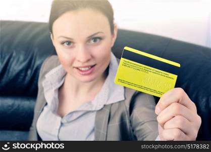 Business woman holds a credit card