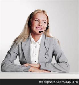 business woman in a headset on a gray background