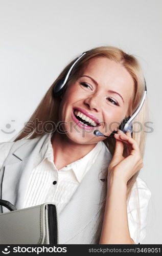 business woman in a headset on a gray background