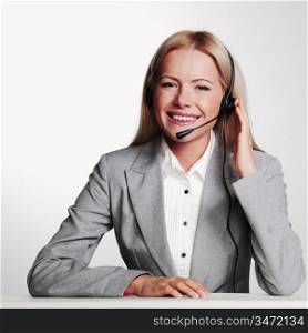 business woman in a headset on a gray background