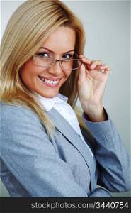 business woman in glasses on gray background