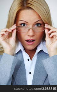 business woman in glasses on gray background