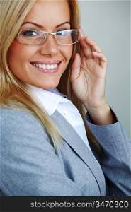business woman in glasses on gray background