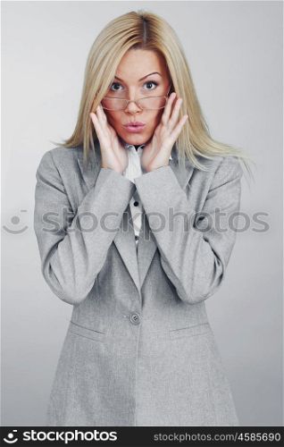 Business woman in glasses on gray background. Business woman in glasses
