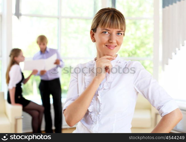 business woman in office and collegues on background