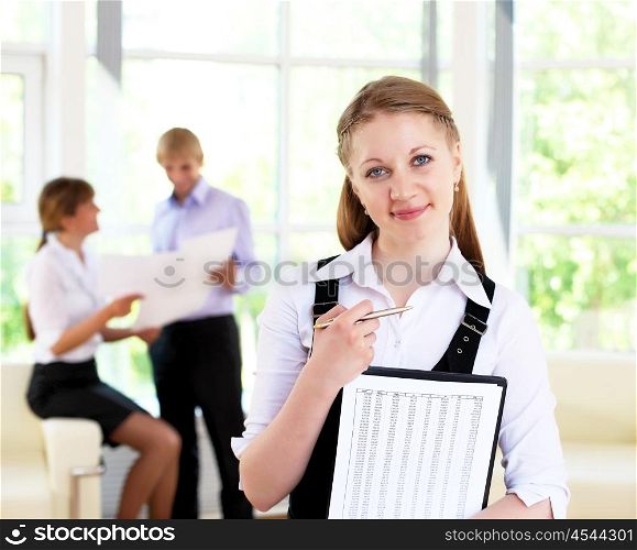 business woman in office and collegues on background
