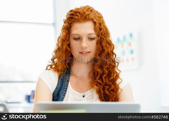 Business woman in office. Young and pretty business woman working in office